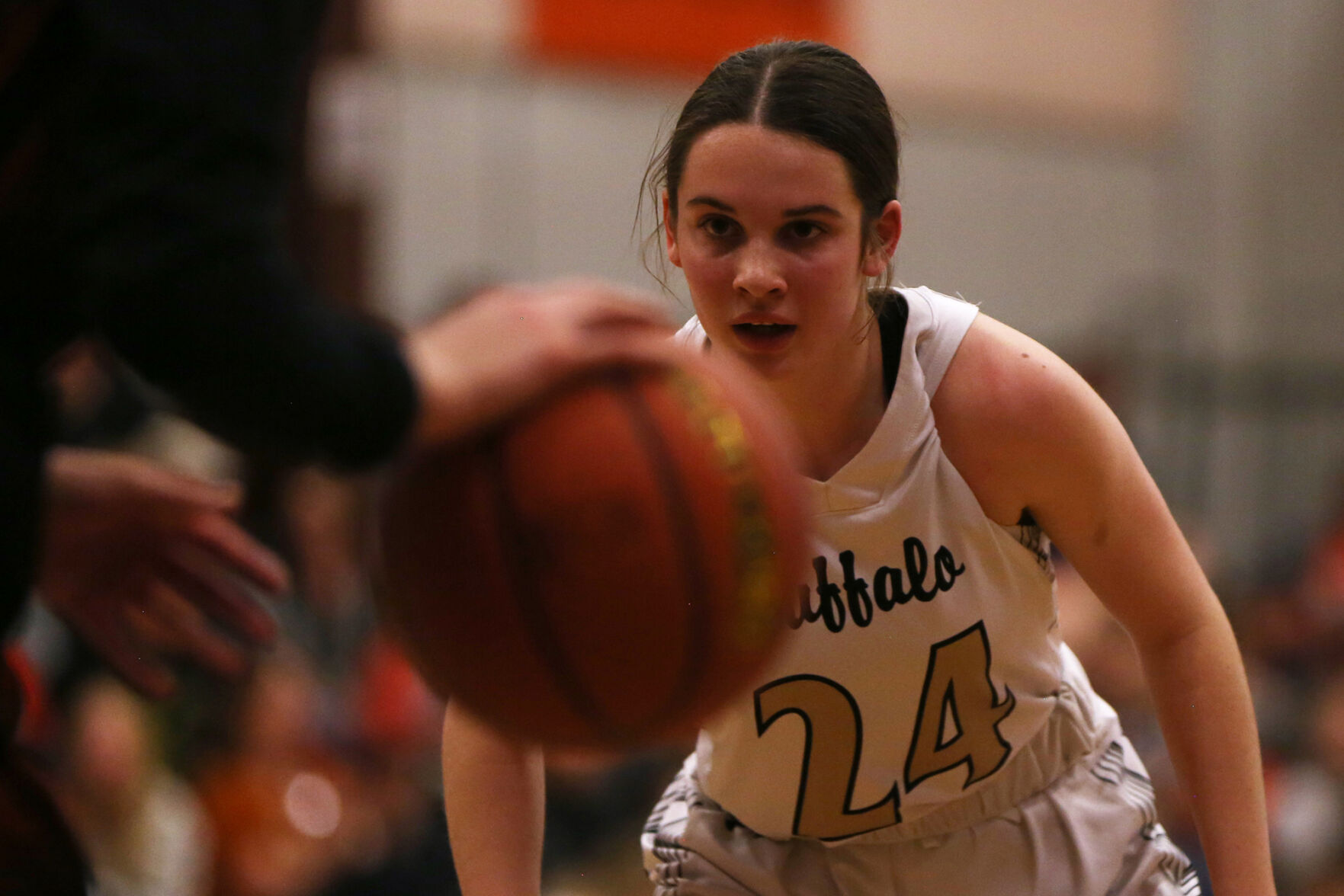Cassidy Bessler watches the ball as she moves backward across the court